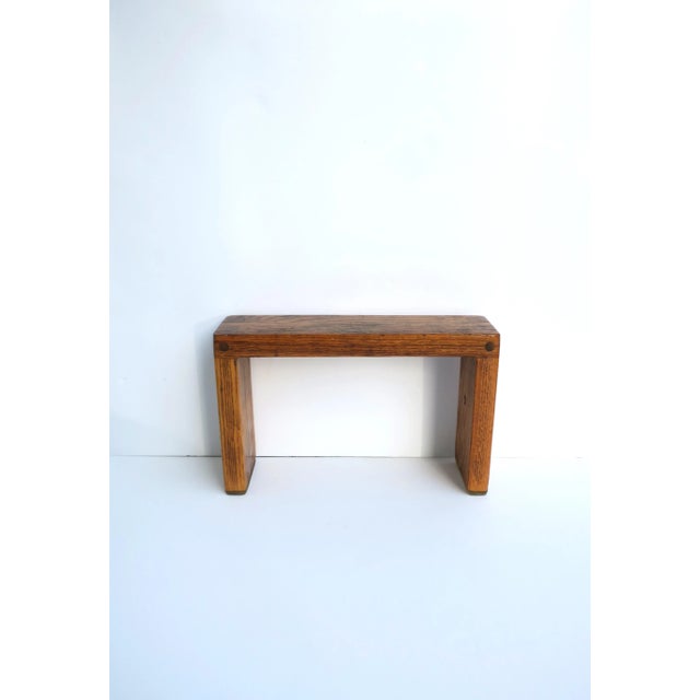 A small, solid, rectangular oak wood stand, beautifully made, circa late-20th century. Piece may work well to hold a...