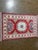 Hand-knotted Pakistani Kazak wool runner featuring a red field with a central geometric medallion and stylized tribal...