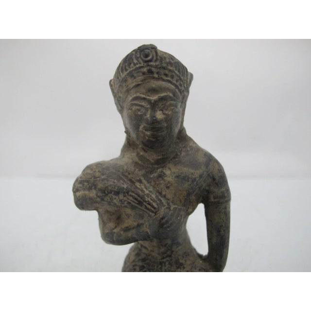 Old Bronze statue of kneeling Phra Mae Phosop, the Thai Rice Goddess or deity for crop abundance. Mae Phosop is the...