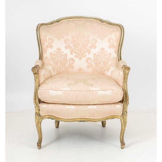 Louis XV Style Pink Silk Damask Upholstered Bergere, giltwood frame with cabriole legs. 35" H x 27.25" W x 30" D; seat:...