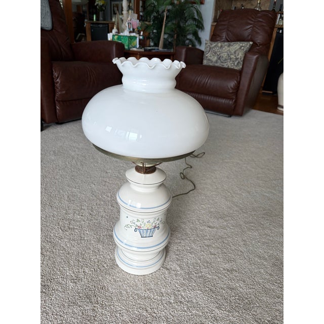 Bring timeless cottage charm to your home with this beautiful vintage hurricane table lamp featuring a glossy white milk...