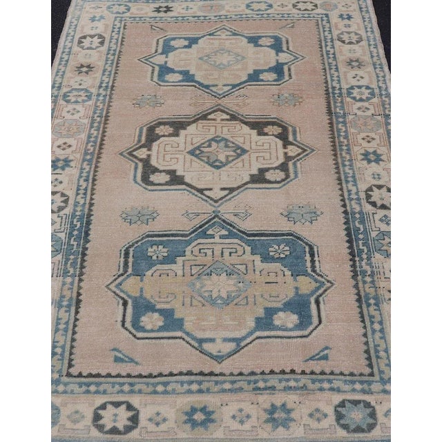Measures: 4'9 x 7'6 This Vintage Turkish Oushak rug is a captivating piece that brings together soft beige and blue tones...