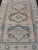 Measures: 4'9 x 7'6 This Vintage Turkish Oushak rug is a captivating piece that brings together soft beige and blue tones...