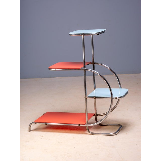 An elegant Bauhaus plant stand designed by Emile Guyot, featuring a graceful chrome-plated tubular steel frame fitted with...
