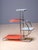 An elegant Bauhaus plant stand designed by Emile Guyot, featuring a graceful chrome-plated tubular steel frame fitted with...