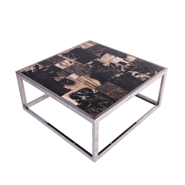 The top of this coffee table is made of petrified wood slices which are hand polished to show its beautiful natural...