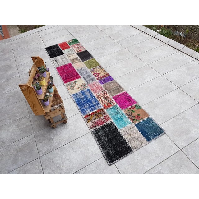 This is a vintage Turkish Oushak rug from the Mid 20th Century. The piece was hand-knotted.