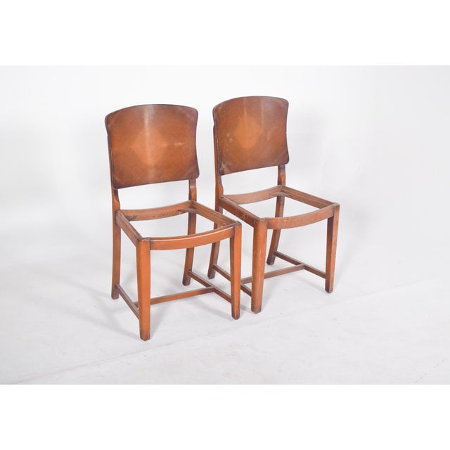 Pair of chairs, without seats. Slightly curved ergonomic backrests, in a single piece of moulded wood, with a diamond...