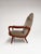 Great vintage armchair from the 1960s. The organically shaped wooden armrests immediately catch the eye. The lounge chair...