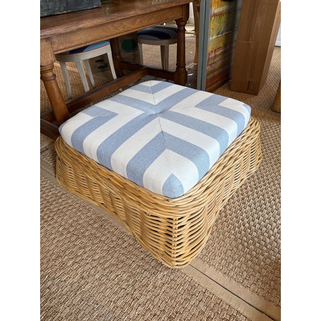Woven rattan ottoman newly upholstered in a crisp, timeless blue-and-white cabana stripe fabric. Tightly woven natural...