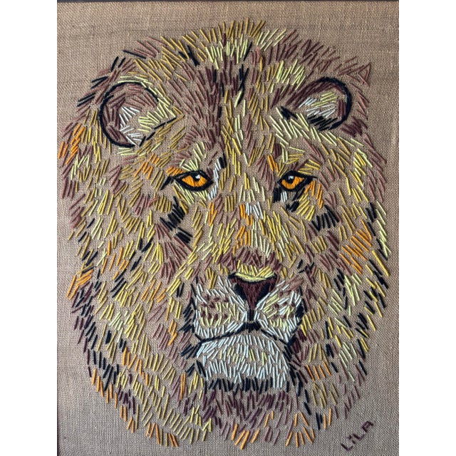 A striking vintage handmade lion needlepoint from the 1960s, featuring a richly textured composition rendered in layered...