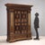 Mannerist wardrobe in lacquered walnut, with walnut parts, painted parts and gold leaf gilded parts. Front with pair of...