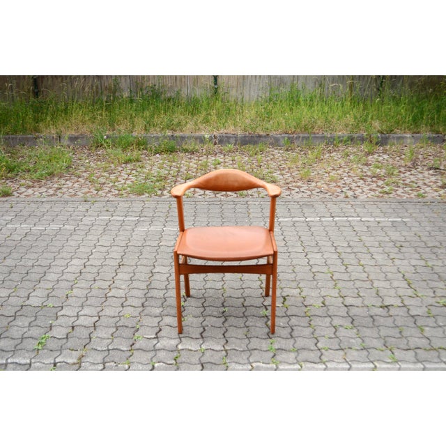 Mid-century modern armchair in teak, designed by Erik Kirkegaard for Høng Stolefabrik, Denmark, model 49. Curved backrest...