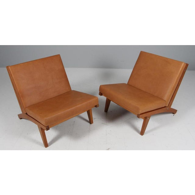 Hans j. Wegner lounge chair with loose cushions new upholstered with vintage tan full grain aniline leather. Frame of...