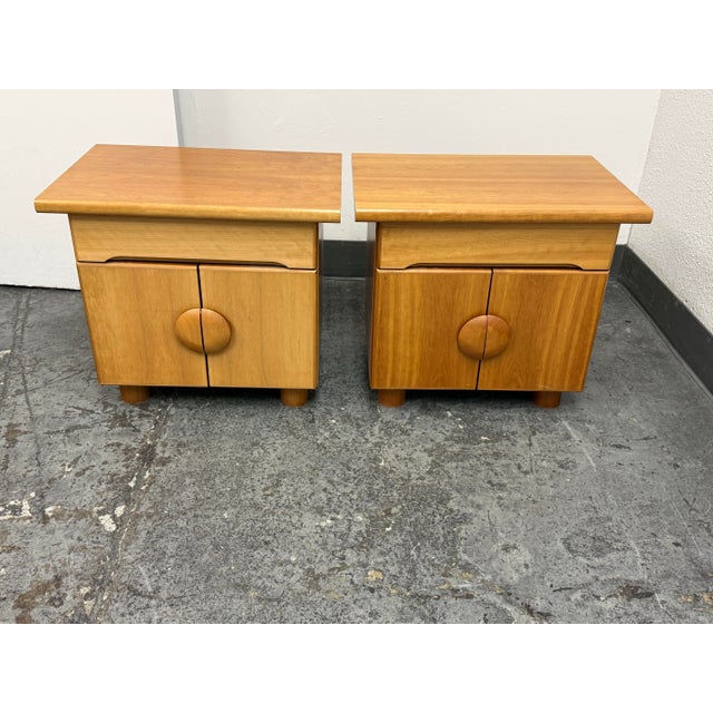 Design Plus Gallery presents a Pair of Mid 20th Century Danish Modern Cherry Nightstands. Each nightstand has a cherry-...