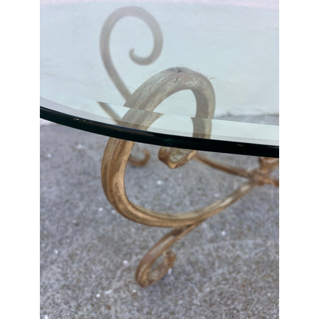 1970s Vintage Hollywood Regency Style Coffee Table Featuring a Gold-Finished Wrought Iron Base With Scrollwork and an Oval Beveled Glass Top For Sale - Image 5 of 7