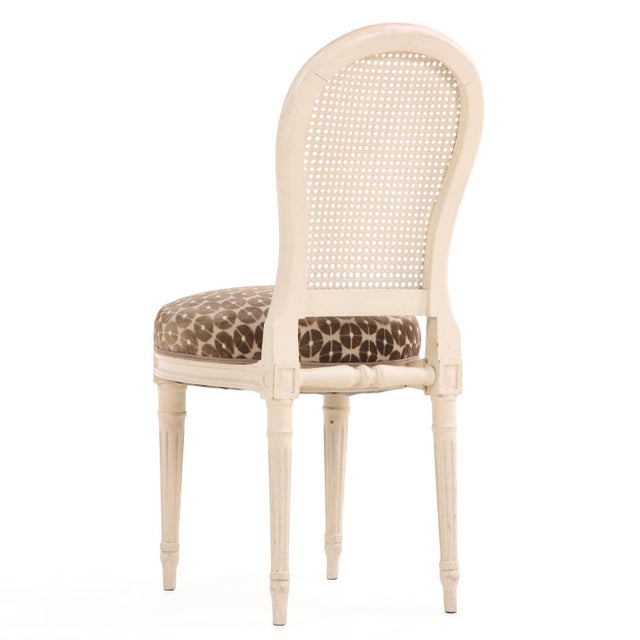 This elegant set of four dining or salon chairs showcases the refined neoclassicism of the Directoire style, crafted...