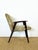 Vintage armchair with a scandinavian design typical of the mid-20th century. its dark-stained solid wood frame offers...