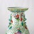 A Chinese Famille Rose porcelain vase from the 20th century, featuring intricate floral and vine patterns in vibrant...