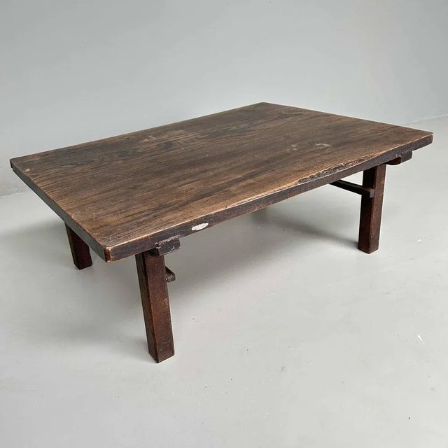 Simple small wooden table from the 1920s, Japan. The beautifully aged and weathered wood, combined with the minimalist...