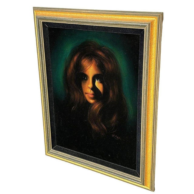 This exquisite mid-century oil on velvet painting features a captivating portrait of a young green-eyed woman. The...