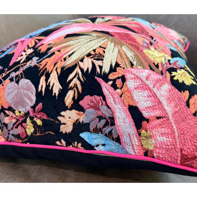 Vibrant coral pink and icy turquoise tropical foliage emerges from a deep black foundation, constructed entirely through...