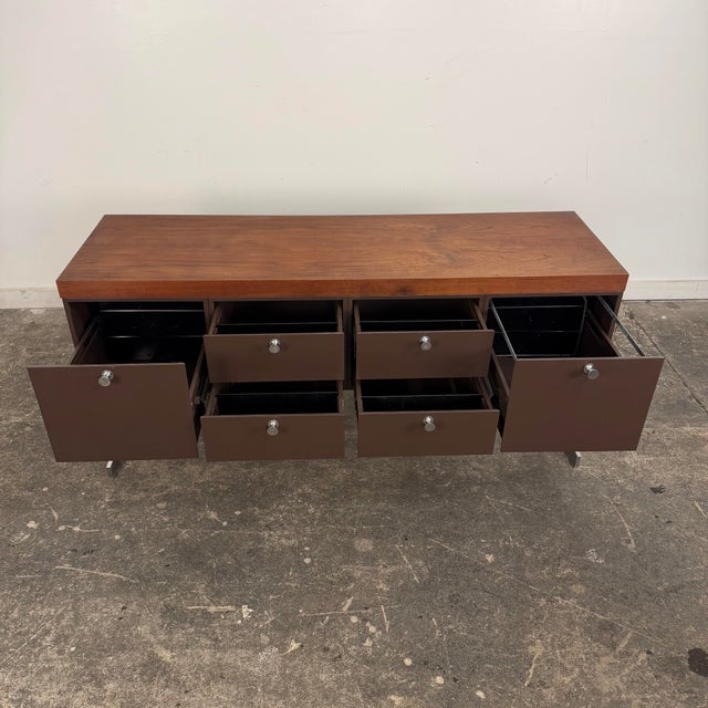 This is a mid 20th century steel and walnut credenza, produced by the Peerless Steel Equipment Company in Philadelphia,...