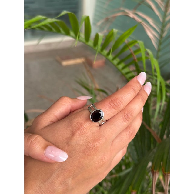 This elegant Garnet Solitaire Ring is beautifully crafted in 925 Sterling Silver with a modern double-row band design. The...