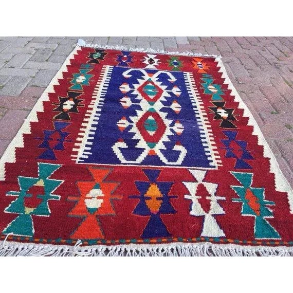 This beautiful, traditional vintage, flatweaved Turkish kilim rug is approximately 60 years old. It is handmade of very...
