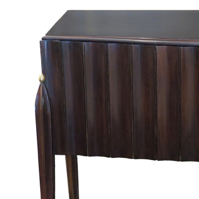 Elegant Mid-Century console cabinet in Mahogany with a satin finish. The front and sides are decorated in a fluted design...