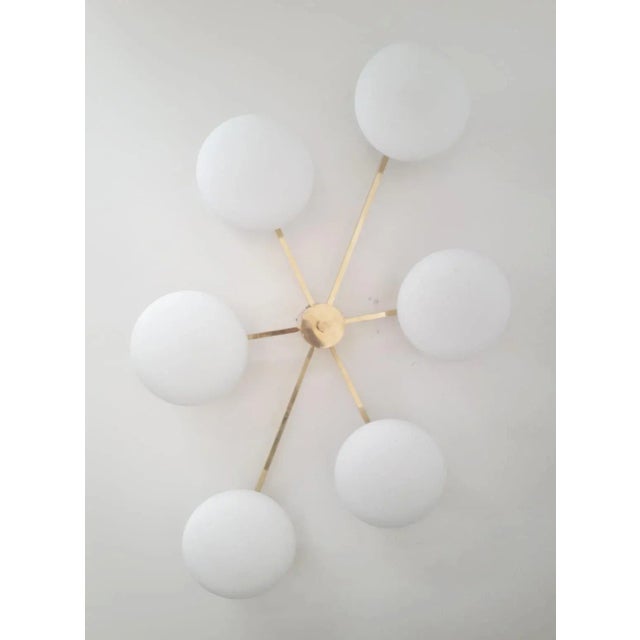Italian asymmetrical flush mount with six matte white Murano glass shades mounted on solid brass frame in unlacquered...