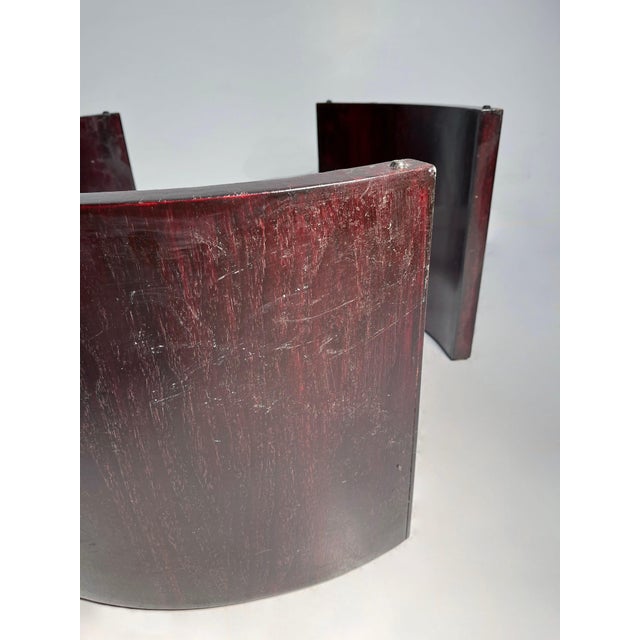 Wood Legs joined by a chromed metal structure. This one was refinished in a darkish red. wood base diameter is about 29"...