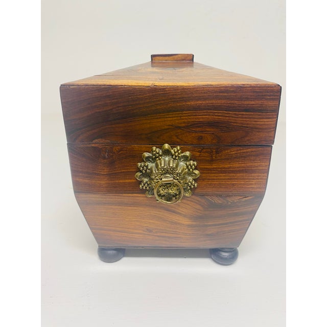 This is a mid 19th century handmade Rosewood tea caddy. The tea caddy has its original glass disposal bowl in the center...