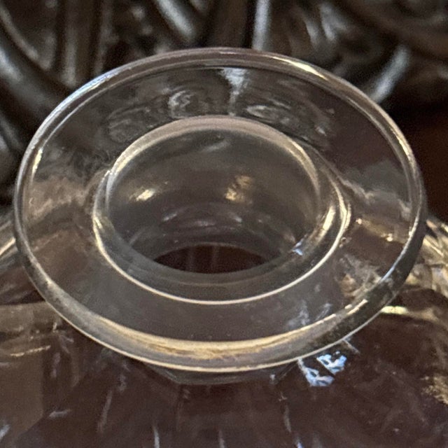 antique cut-glass or crystal perfume and cologne bottle featuring a starburst or hobstar-cut base and a round top with a...