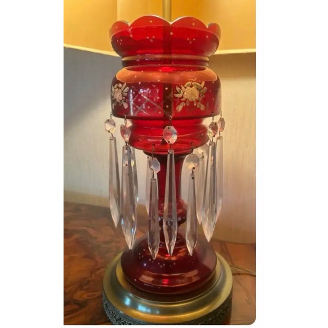 An exceptional late 19th-century Bohemian cranberry glass lustre table lamp featuring richly colored ruby glass decorated...