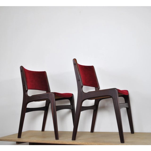 Set of two dining chairs designed by Erik Buch for Odense Maskinsnedkeri. Solid teak frames with fabric upholstered seats...