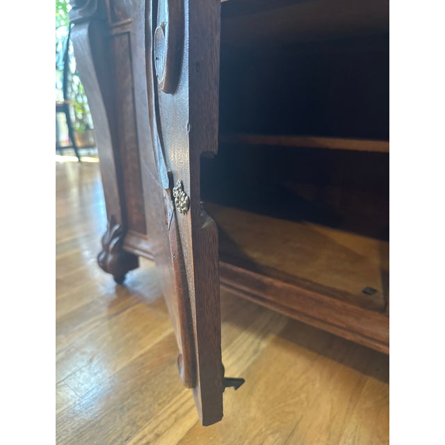 This is a substantial antique carved oak buffet / sideboard with upper display cabinet, dating to the late 19th to early...