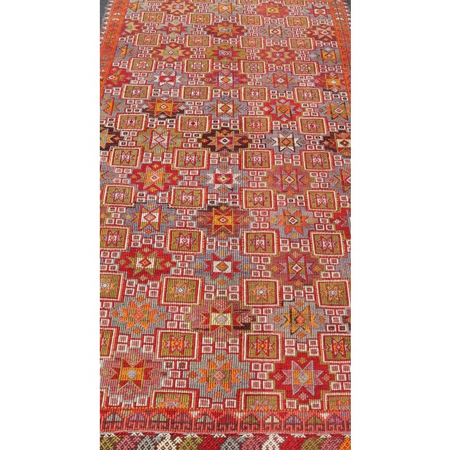 Measures: 4'6" x 10'2" Vintage Turkish Kilim Rug with Rich Red and Multicolor Motif Design 4'6" x 10'2". Vintage Turkish...