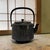 This Japanese Nambu Tekki Tetsubin by Shofudo is a traditional cast iron tea kettle with raised bamboo stalks and leaves,...