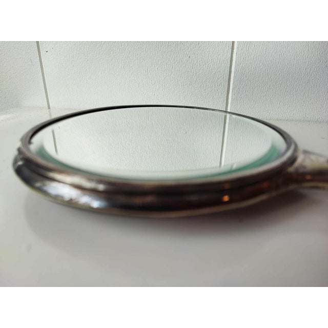 Pre-war plated mirror, dimensions: height 28 cm, diameter 14,5 cm, depth 1.2 cm.