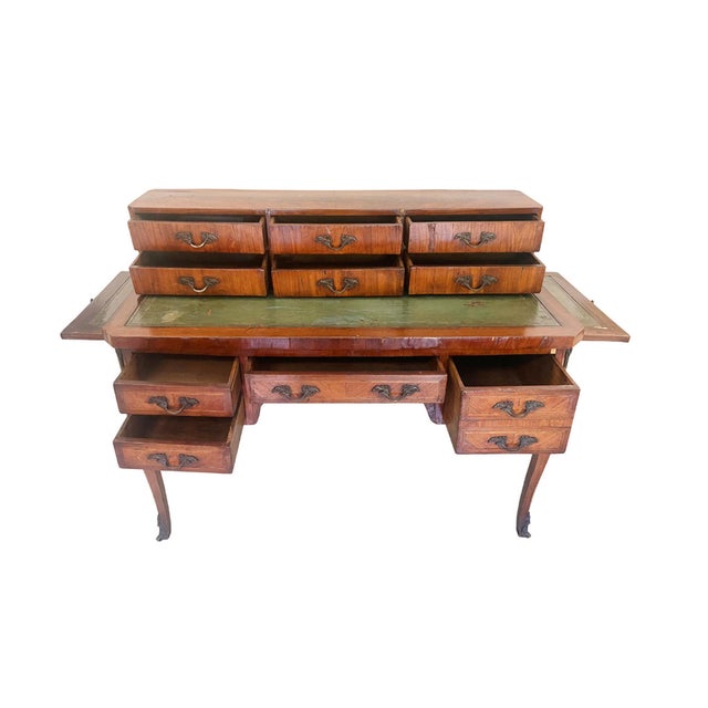 Masterly hand-crafted in the 19th Century, this Louis XV-style desk is comprised of a top cabinet case and a lower desk...