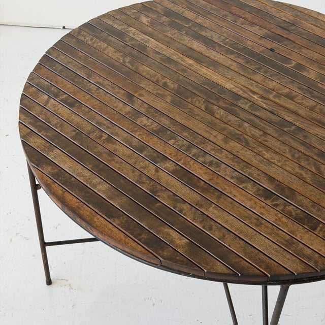 c. 1950s. USA. Iron base with removeable wood slat top. This piece is attributed to the mentioned designer/maker. It has...