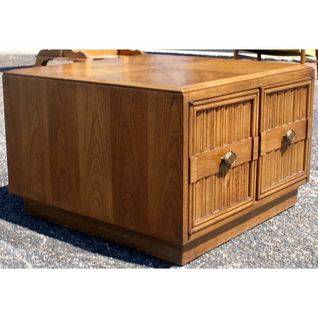 Drexel Pair of two-tone Plaudit by Drexel walnut nightstands with plinth base and panelled doors. Brass pulls. Measures: 27".