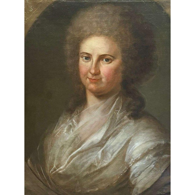 This fine oil on canvas portrait depicts a young woman in three-quarter profile and represents an excellent example of...
