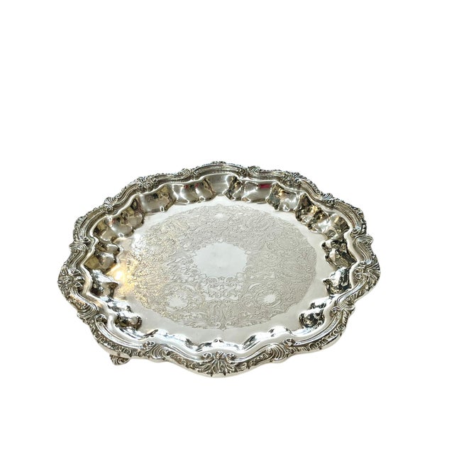 A fine vintage silver plated footed tray or salver. Marked English Silver MFG Corp on the back. This gorgeous tray is a...