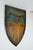 This shield shaped wooden piece displays Junior Carlton Cricket Club, Captain Fogilvy, Umpire G. Mundy, Summer Fixtures...