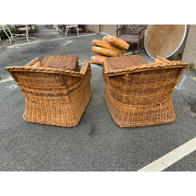 20th century Kreiss wicker chairs and ottoman set. Loose back and seat cushions, fixed back seat cushion.No cushions on...
