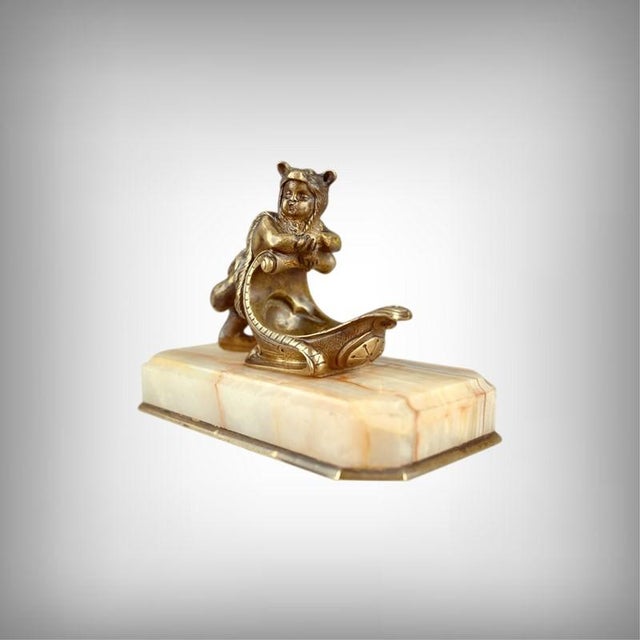 This late 19th-century paperweight, a refined combination of patinated bronze and onyx, stands out as a rare and exquisite...