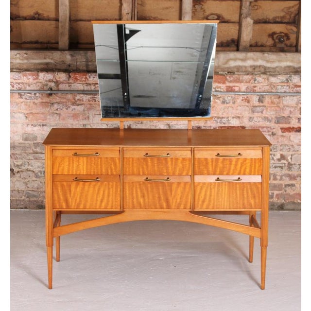 French Mid Century mahogany dressing table with a mirror, circa 1960s. 6 drawers with brass handles. Beautiful flamed...