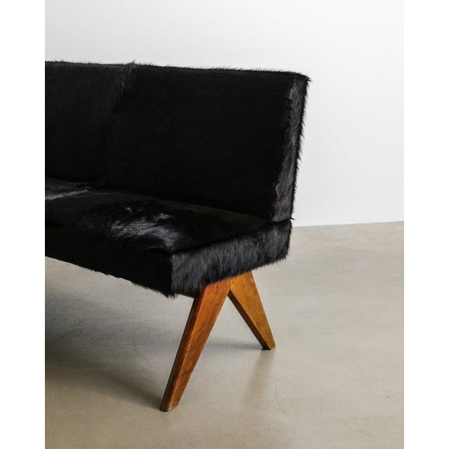 A very rare and iconic french mid century wooden "public bench" in dark stained teak and newer dark brown pony hair...